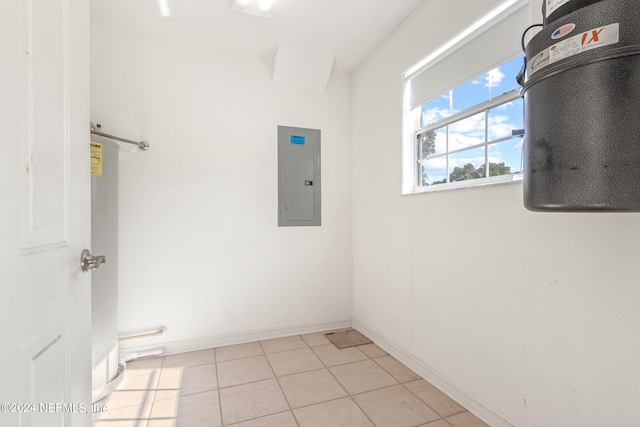 clothes washing area featuring light tile floors