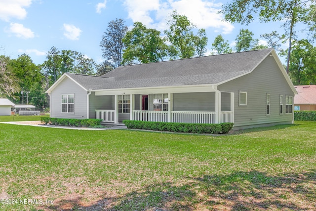 ranch-style house with covered porch and a front yard