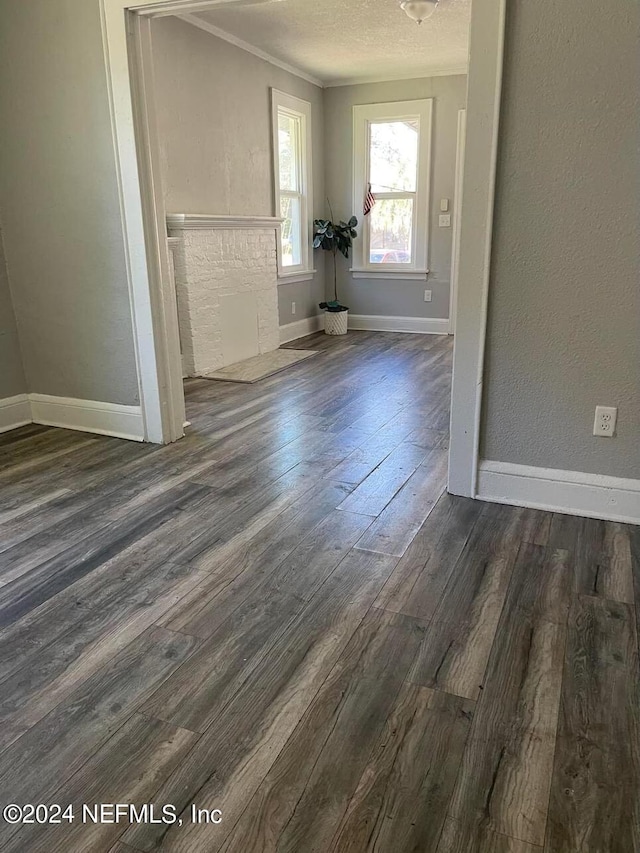 unfurnished room with dark hardwood / wood-style floors and a textured ceiling