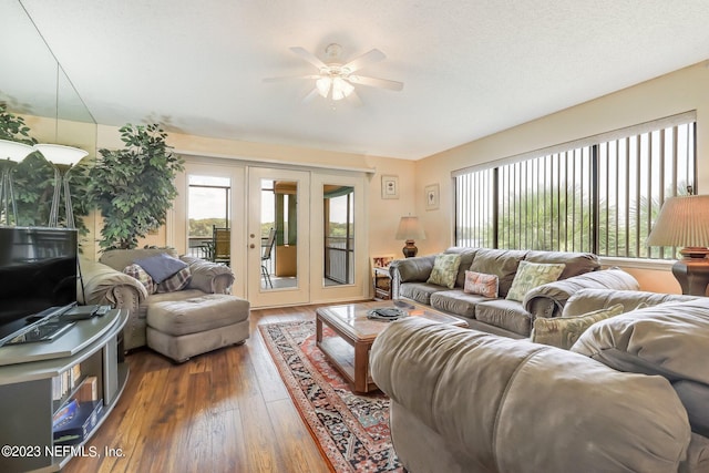 living room featuring a textured ceiling, dark hardwood / wood-style flooring, ceiling fan, and french doors