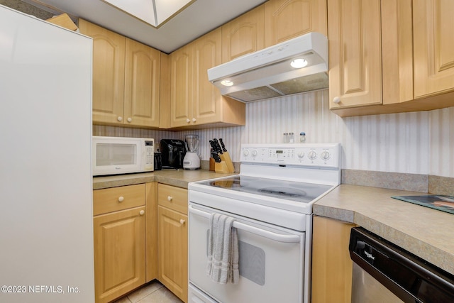 kitchen featuring white appliances and light brown cabinetry