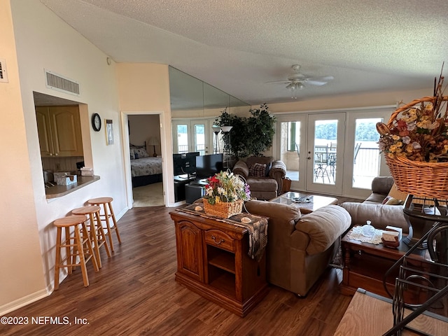 living room with dark hardwood / wood-style flooring, ceiling fan, a textured ceiling, and plenty of natural light