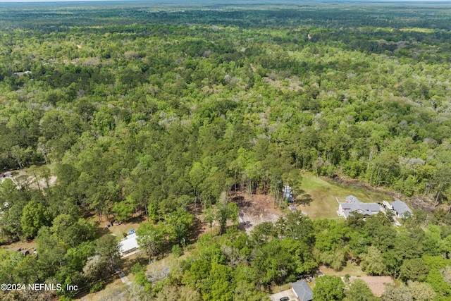 birds eye view of property with a wooded view