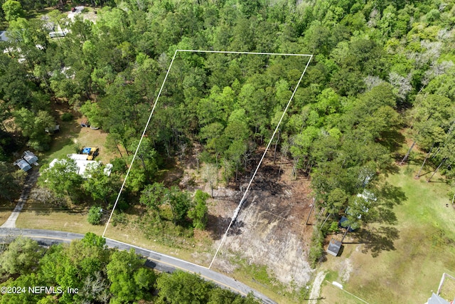 aerial view featuring a wooded view