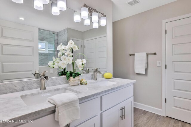 bathroom featuring double sink vanity and hardwood / wood-style flooring