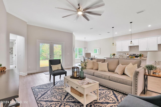 living room with baseboards, recessed lighting, visible vents, and light wood-style floors