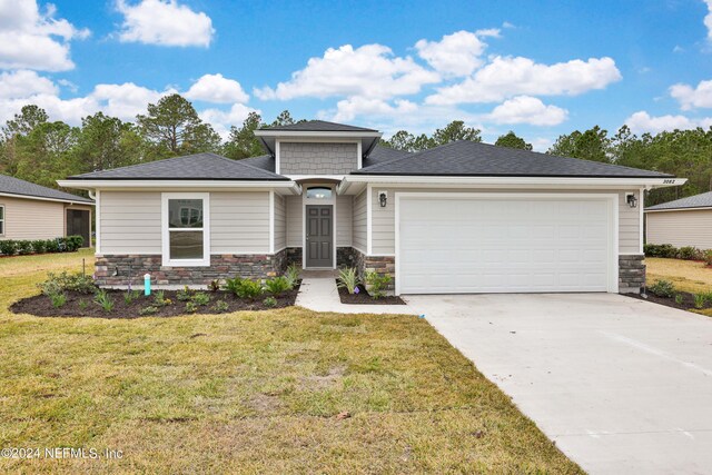 prairie-style home with a garage and a front lawn