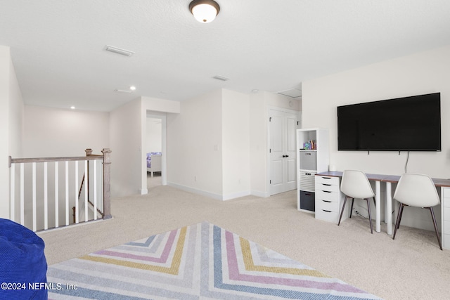 bedroom featuring carpet floors, visible vents, baseboards, and a textured ceiling