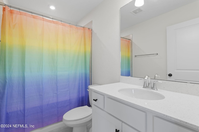 bathroom featuring toilet, a shower with curtain, visible vents, and vanity