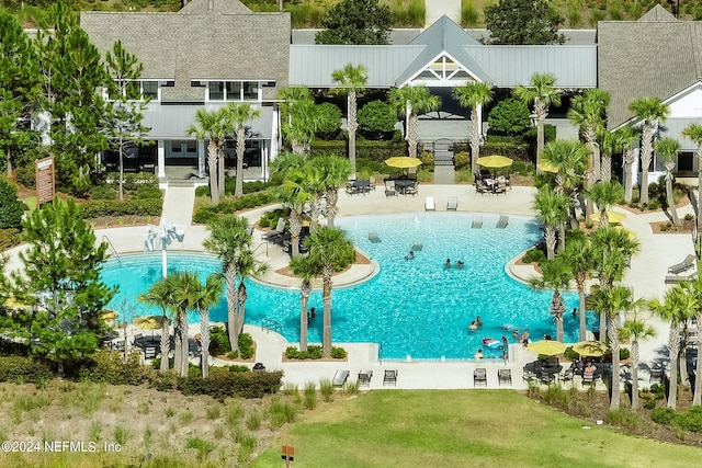 community pool with a patio area and a yard