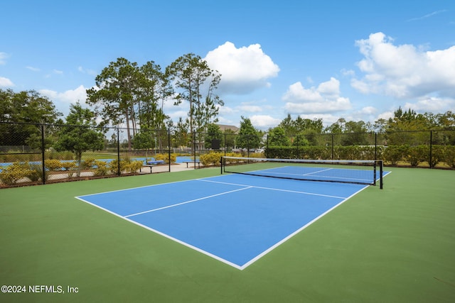 view of sport court with fence