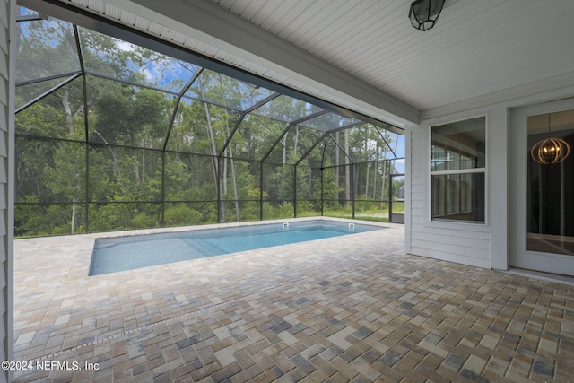 outdoor pool featuring a lanai and a patio