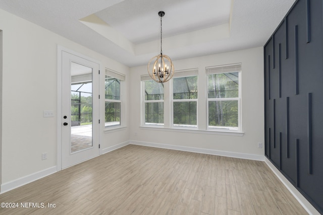 interior space featuring an inviting chandelier and a tray ceiling