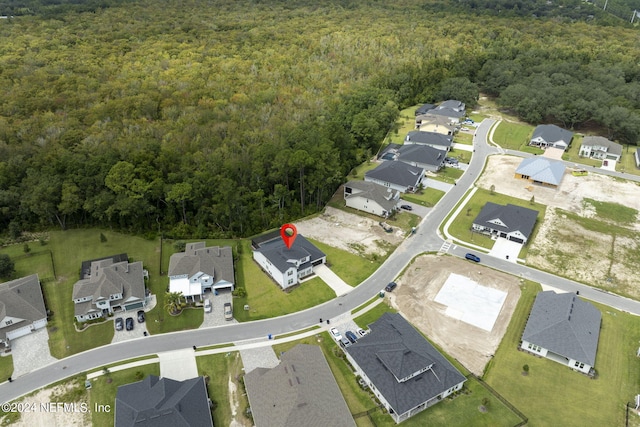 bird's eye view featuring a forest view and a residential view