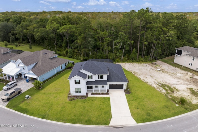 birds eye view of property with a view of trees