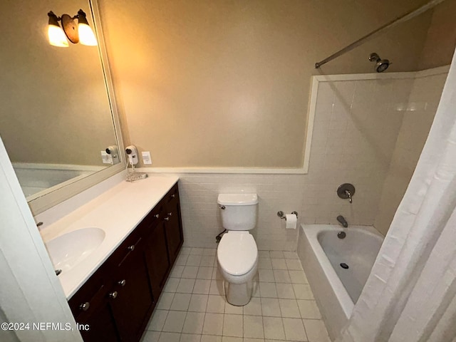 full bathroom with shower / tub combo with curtain, tile patterned flooring, tile walls, toilet, and vanity