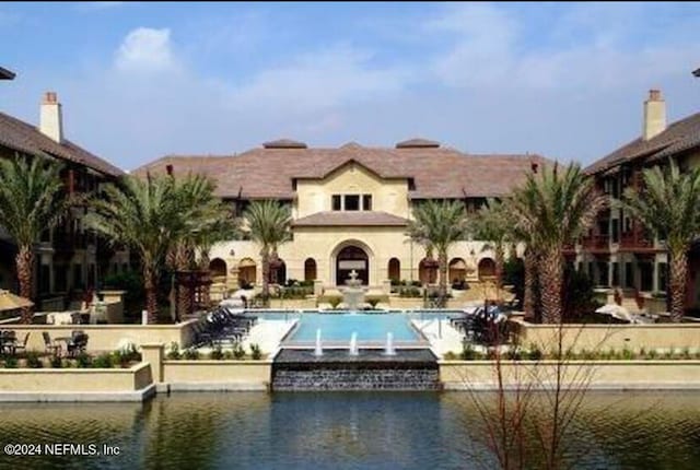 view of swimming pool with a water view