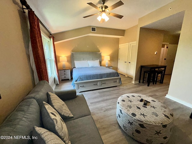 bedroom with lofted ceiling, hardwood / wood-style flooring, and ceiling fan