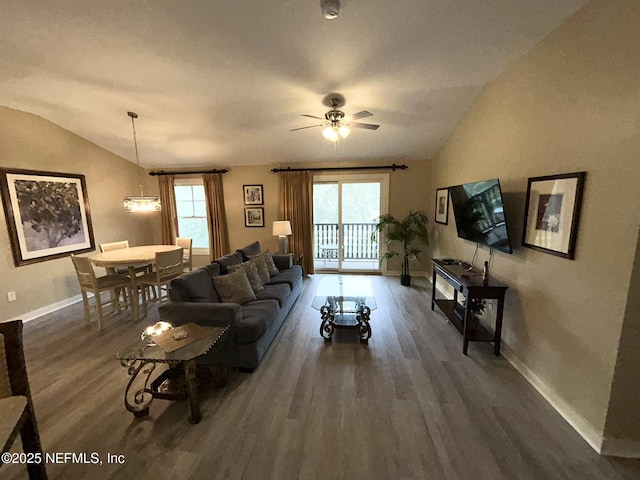 living room featuring ceiling fan, vaulted ceiling, and dark hardwood / wood-style flooring