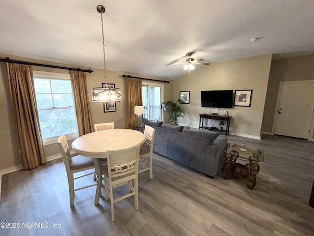 dining area with lofted ceiling, ceiling fan, and wood-type flooring