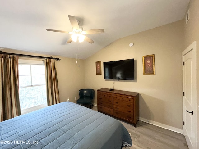 bedroom featuring lofted ceiling, ceiling fan, and hardwood / wood-style flooring