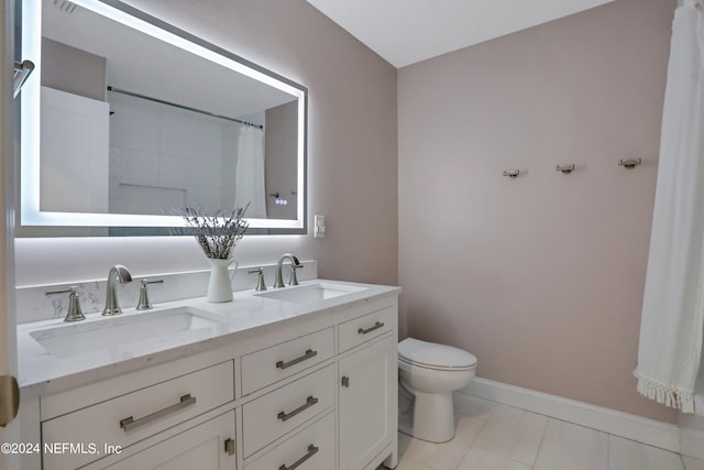 bathroom featuring tile patterned flooring, vanity, toilet, and curtained shower