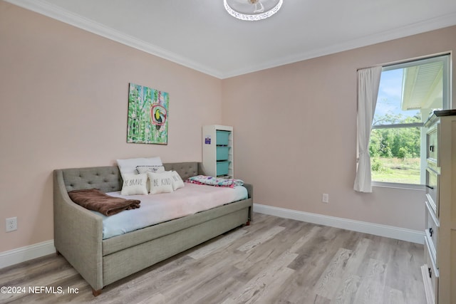 bedroom featuring light wood-type flooring and ornamental molding