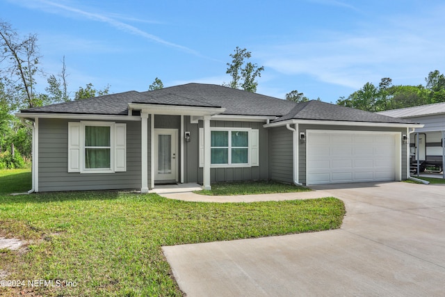 view of front of house featuring a front yard and a garage