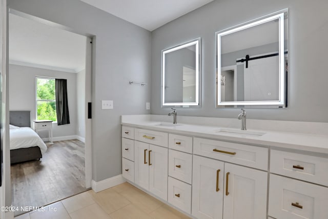 bathroom with hardwood / wood-style floors, vanity, and crown molding