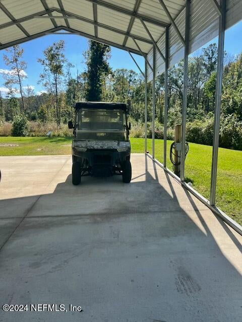 view of car parking featuring a carport and a yard