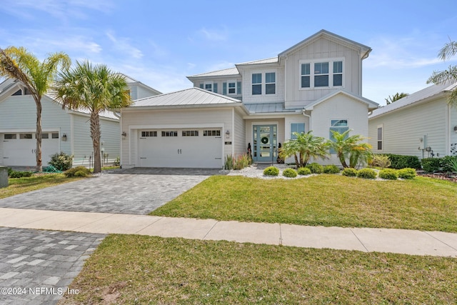 view of front of property with a garage and a front lawn