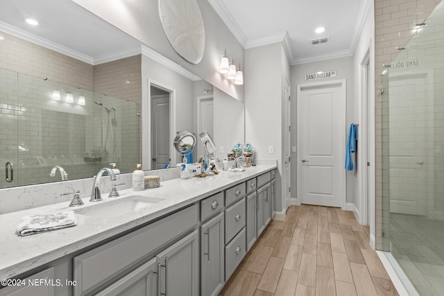 bathroom with crown molding, vanity, and walk in shower