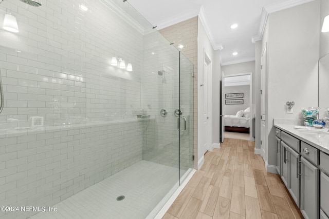 bathroom with vanity, an enclosed shower, and crown molding