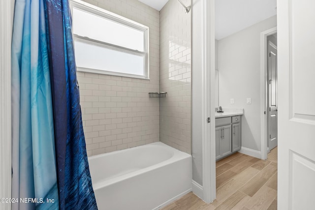 bathroom featuring shower / bath combo with shower curtain and vanity