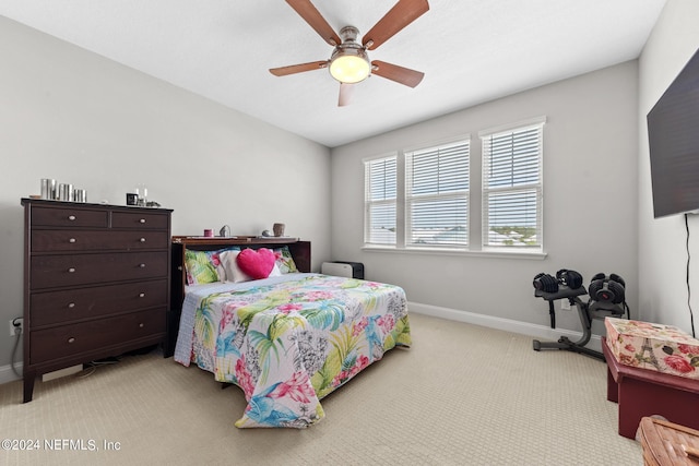 bedroom featuring ceiling fan and light carpet