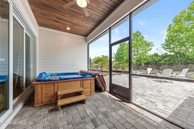 sunroom featuring ceiling fan, wooden ceiling, and a hot tub