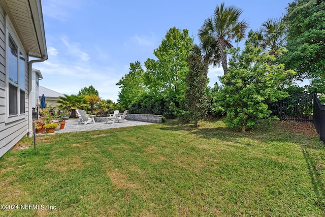 view of yard featuring a patio and an outdoor fire pit