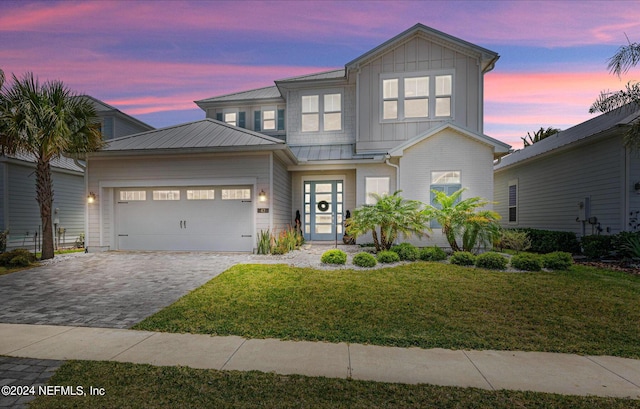 view of front of house featuring a yard and a garage