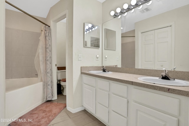 full bathroom with shower / bath combo, double vanity, tile flooring, and toilet