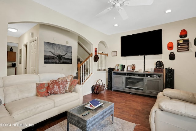 living room with dark hardwood / wood-style floors and ceiling fan