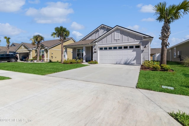 ranch-style home featuring driveway, an attached garage, board and batten siding, and a front yard