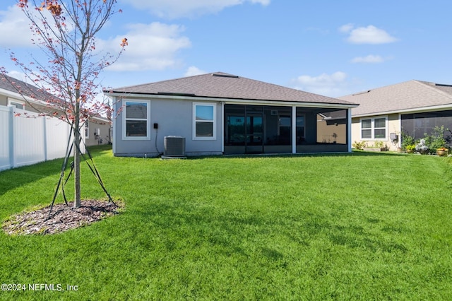 back of property featuring a yard, stucco siding, a sunroom, fence, and cooling unit