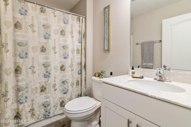 bathroom featuring a textured ceiling, toilet, wood finished floors, vanity, and a shower with curtain