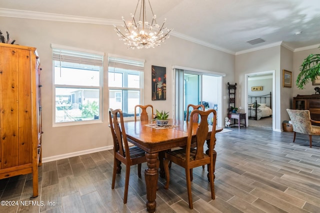 dining space featuring wood tiled floor, crown molding, visible vents, and baseboards