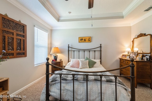 carpeted bedroom featuring baseboards, visible vents, a tray ceiling, a textured ceiling, and crown molding