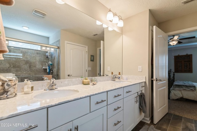 ensuite bathroom with double vanity, ensuite bath, a shower stall, and a sink