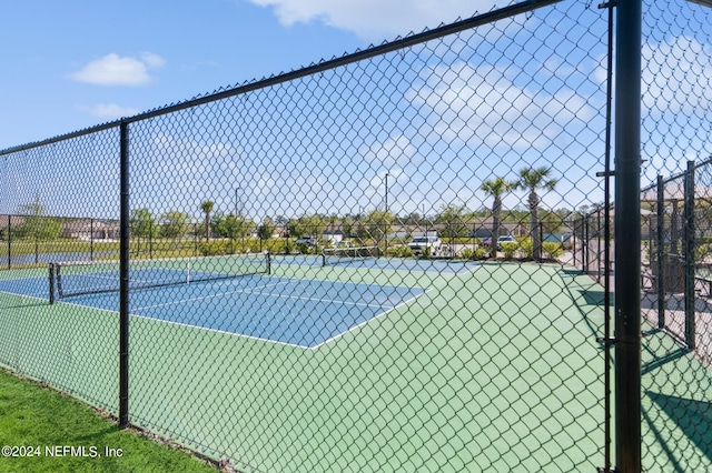 view of tennis court with fence