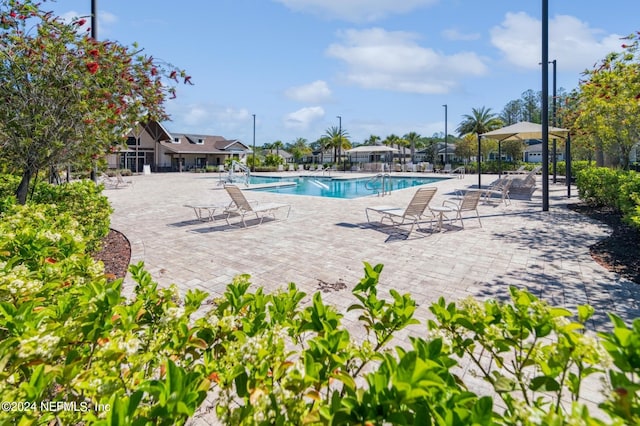 pool with a patio and fence