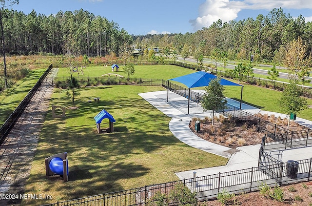 surrounding community featuring fence and a yard