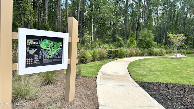 view of property's community featuring a yard